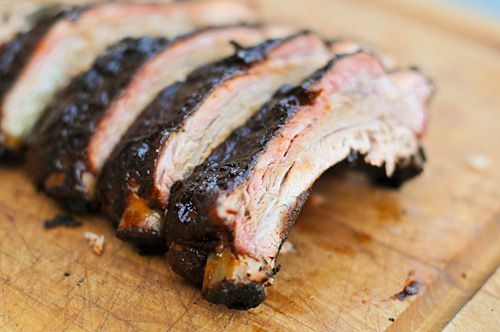 Smoked ribs cut and displayed on wooden cutting board