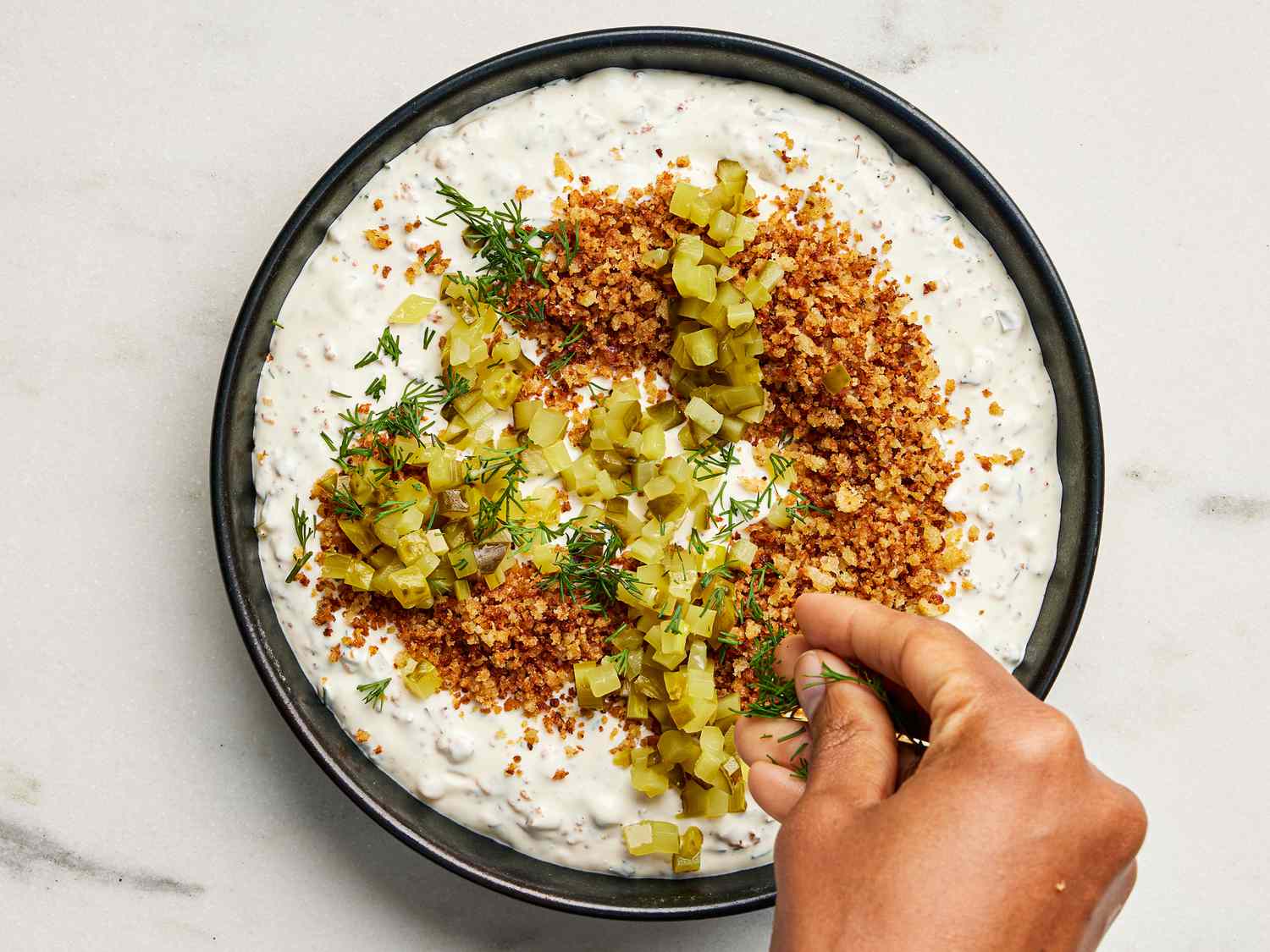 finished dip, garnished with dill, and pickles