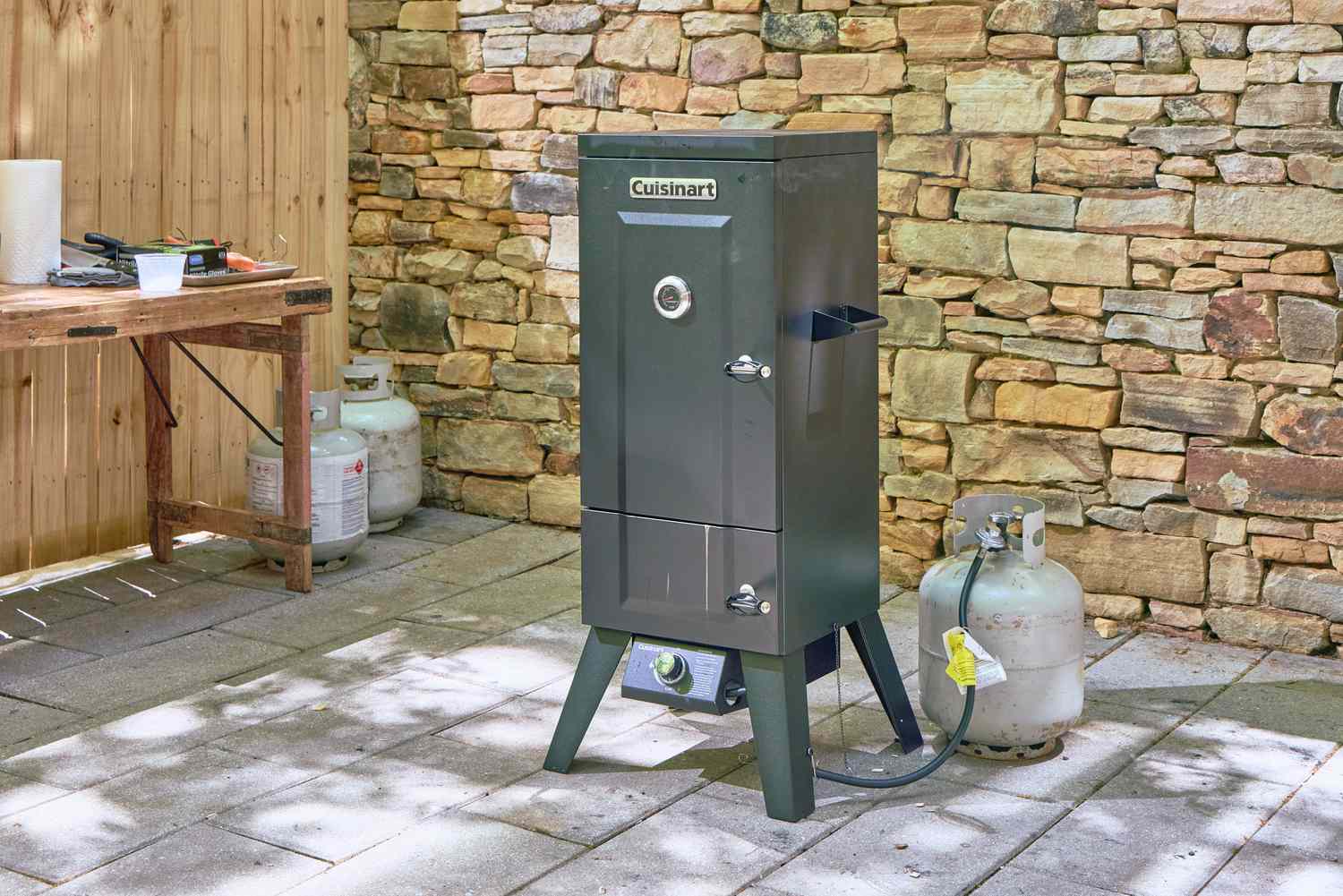 The Cuisinart COS-244 Vertical 36-inch Propane Smoker on a patio