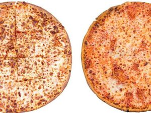 A Papa John's thin crust pizza next to a Domino's thin crust pizza. 