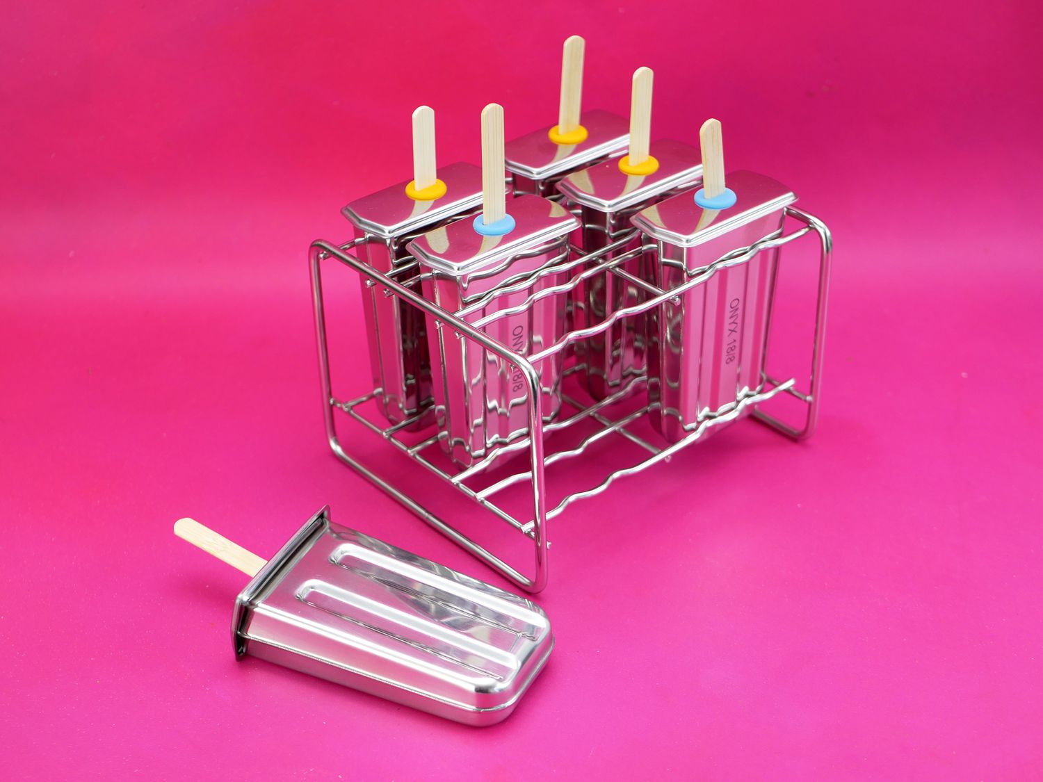 onyx popsicle molds on a pink background