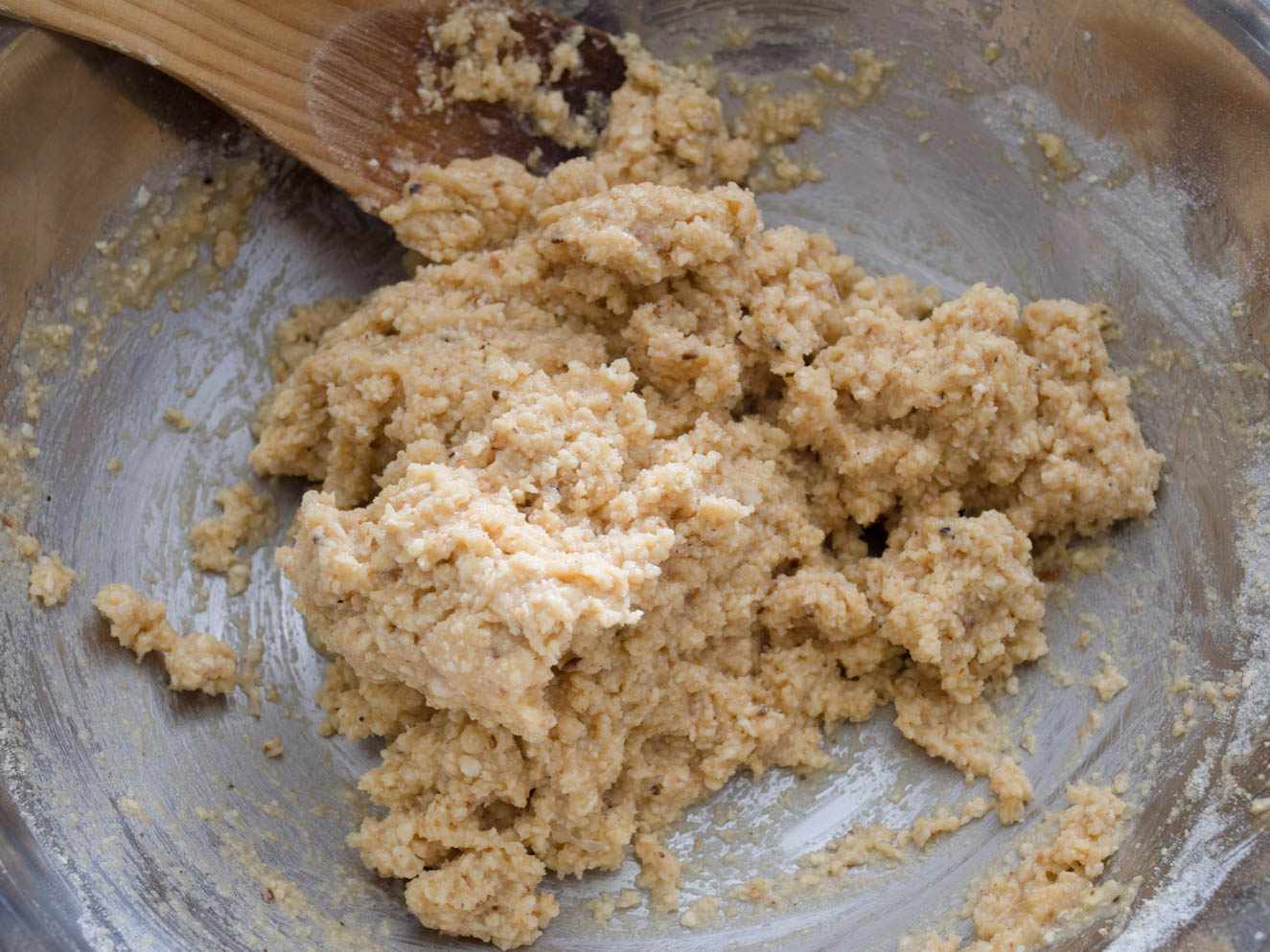 The rested matzo-ball mxiture in the bowl. Piled in the center, the mixture is no longer loose and appears to be holding its shape.