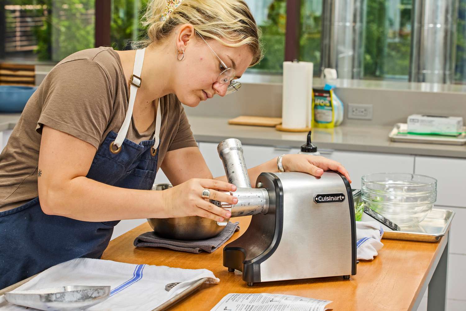 A person assembles the Cuisinart Electric Meat Grinder