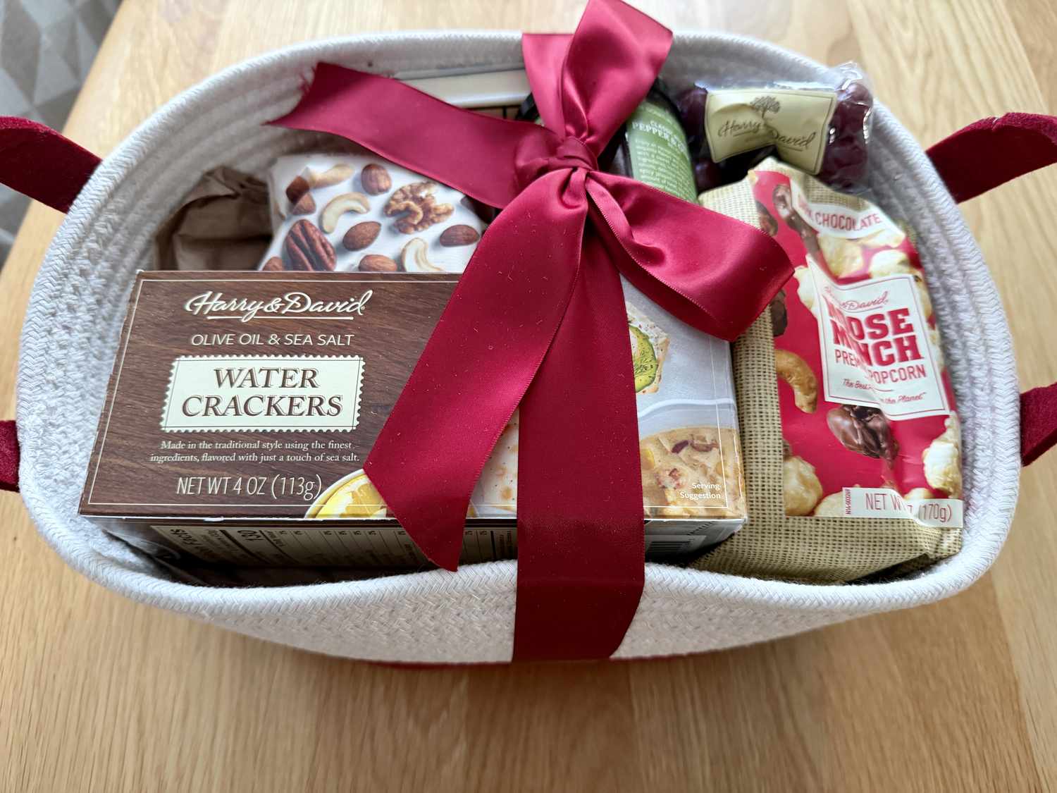 The Harry & David Season's Best Gift Basket tied with a red ribbon