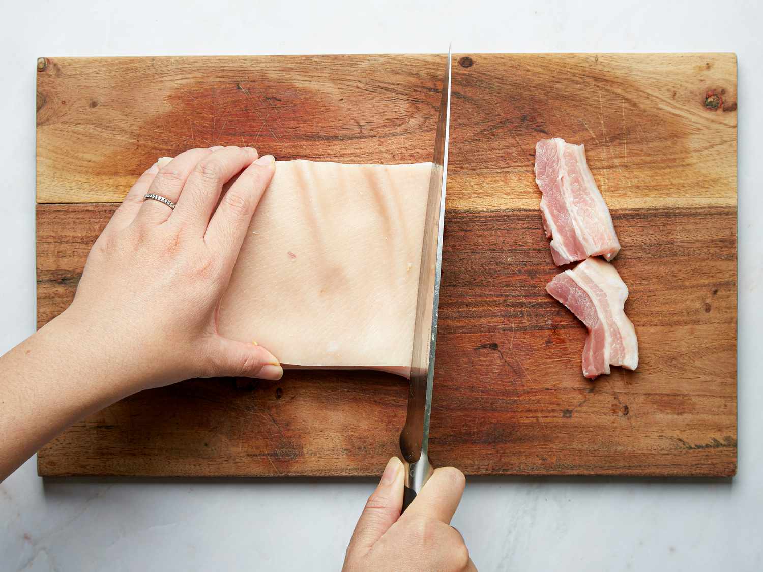 Overhead view of cutting pork belly