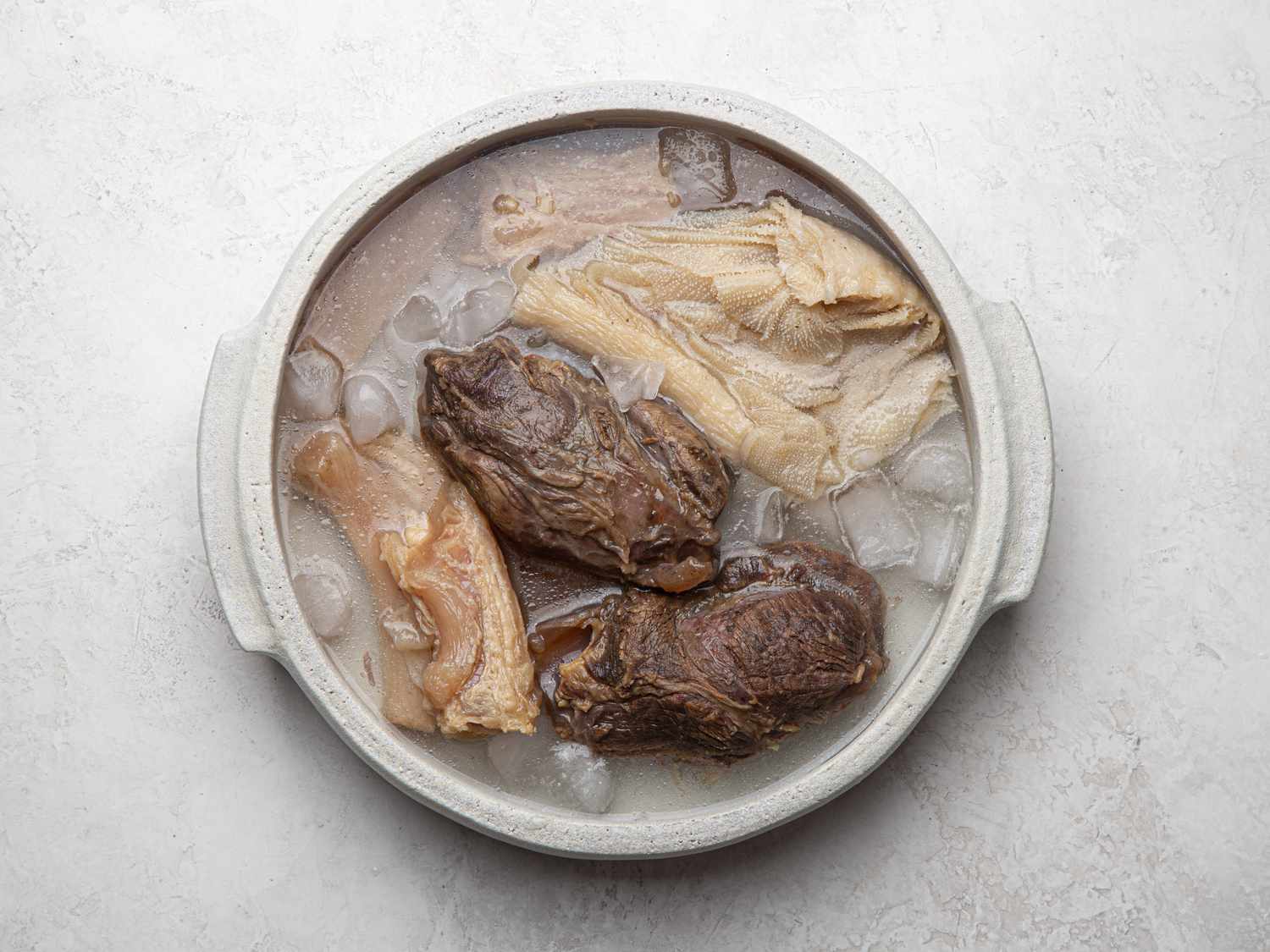 Overhead view of meat in an ice bath