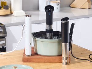 Three sous vide machines on a kitchen countertop.