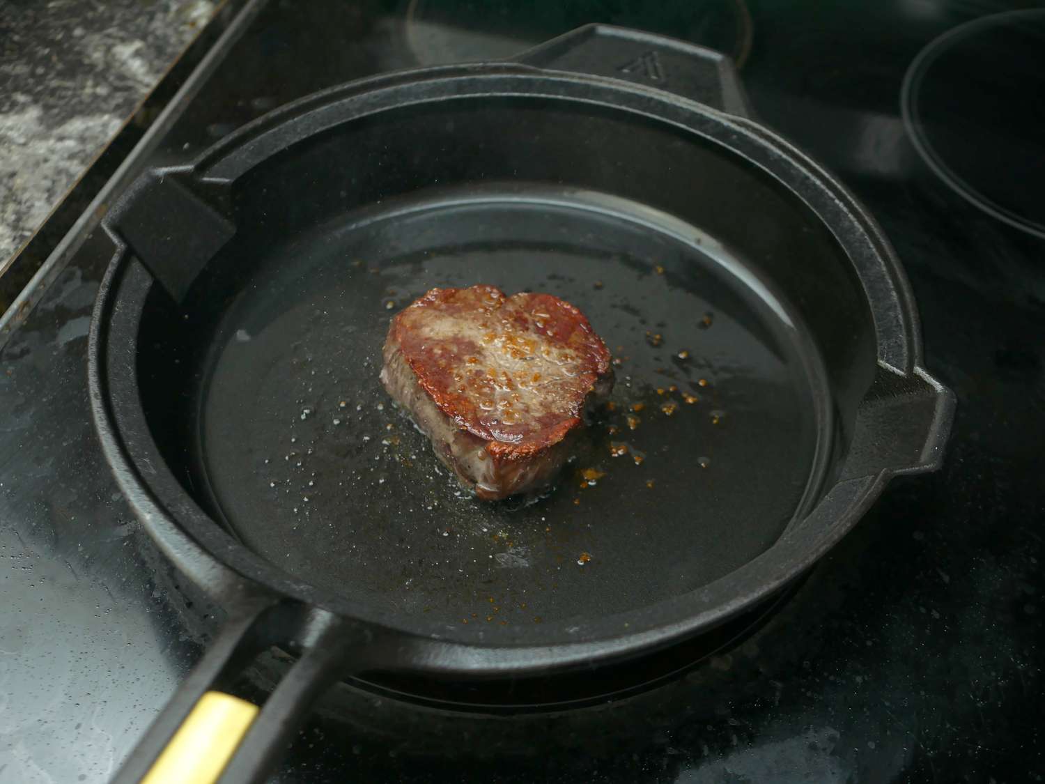filet mignon seared in a cast iron skillet