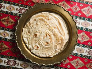 Stack of baked lavash on a serving platter.