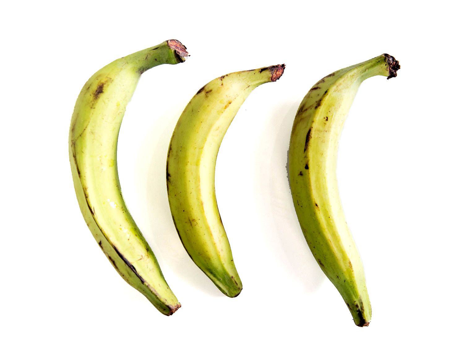 Three slightly ripe plantains, with just a hint of green on the ends but starting to get dark spots.