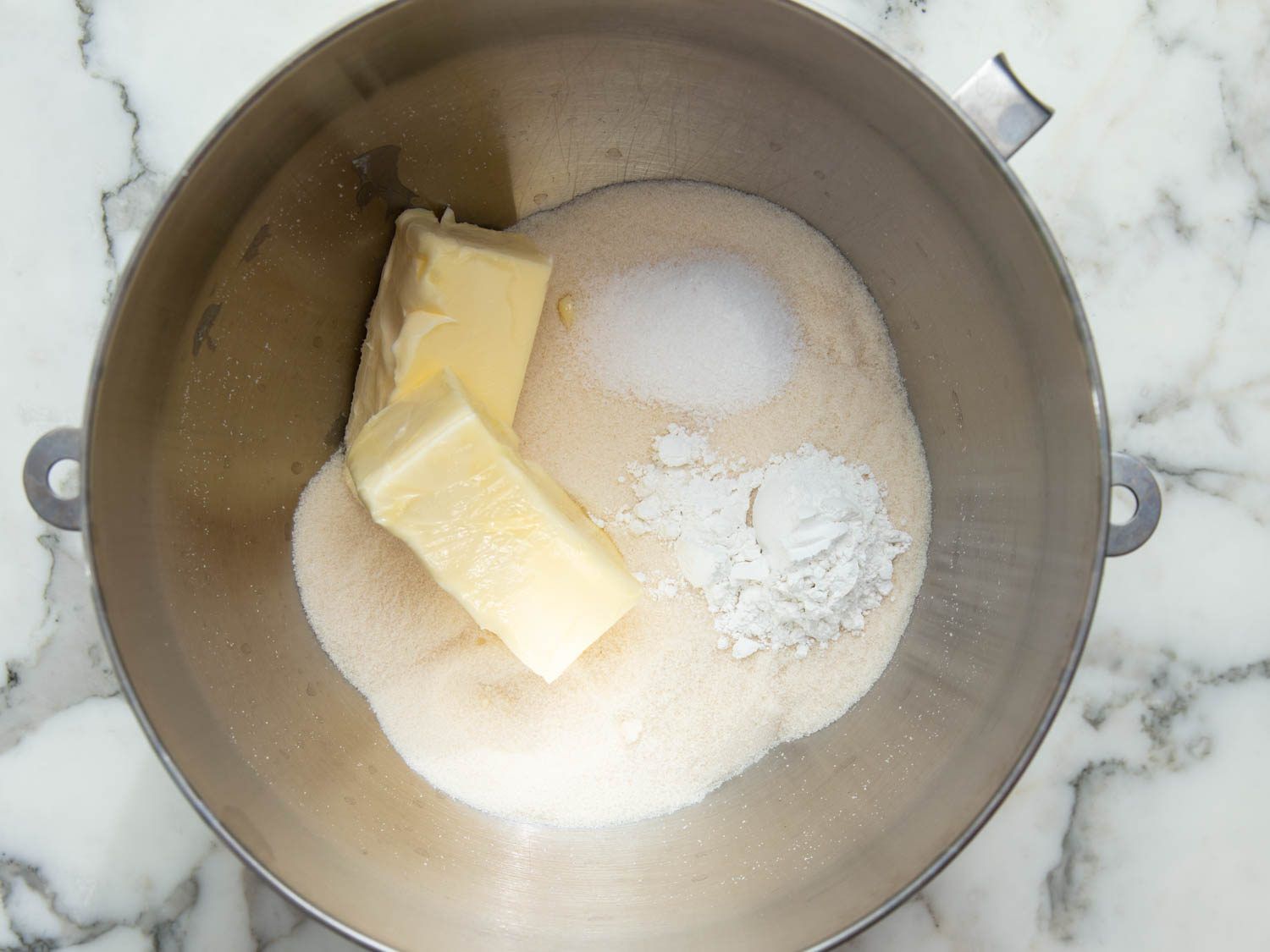 Toasted sugar, baking powder, salt, and butter in the bowl of a stand mixer.