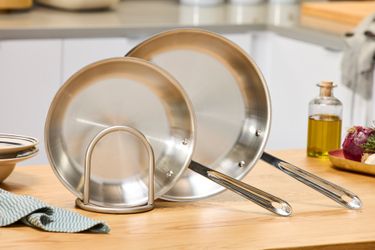 Two All-Clad stainless steel skillets.