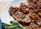 Veal saltimbocca in pan sauce, garnished with fresh sage