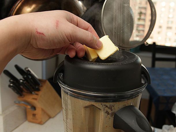 Adding butter to the blended soup one tablespoon at a time.