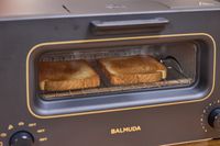 Two slices of toasted bread inside a balmuda toaster oven