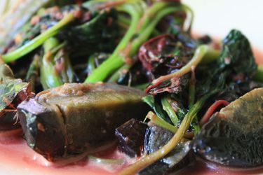 Boiled greens with a preserved duck egg. 