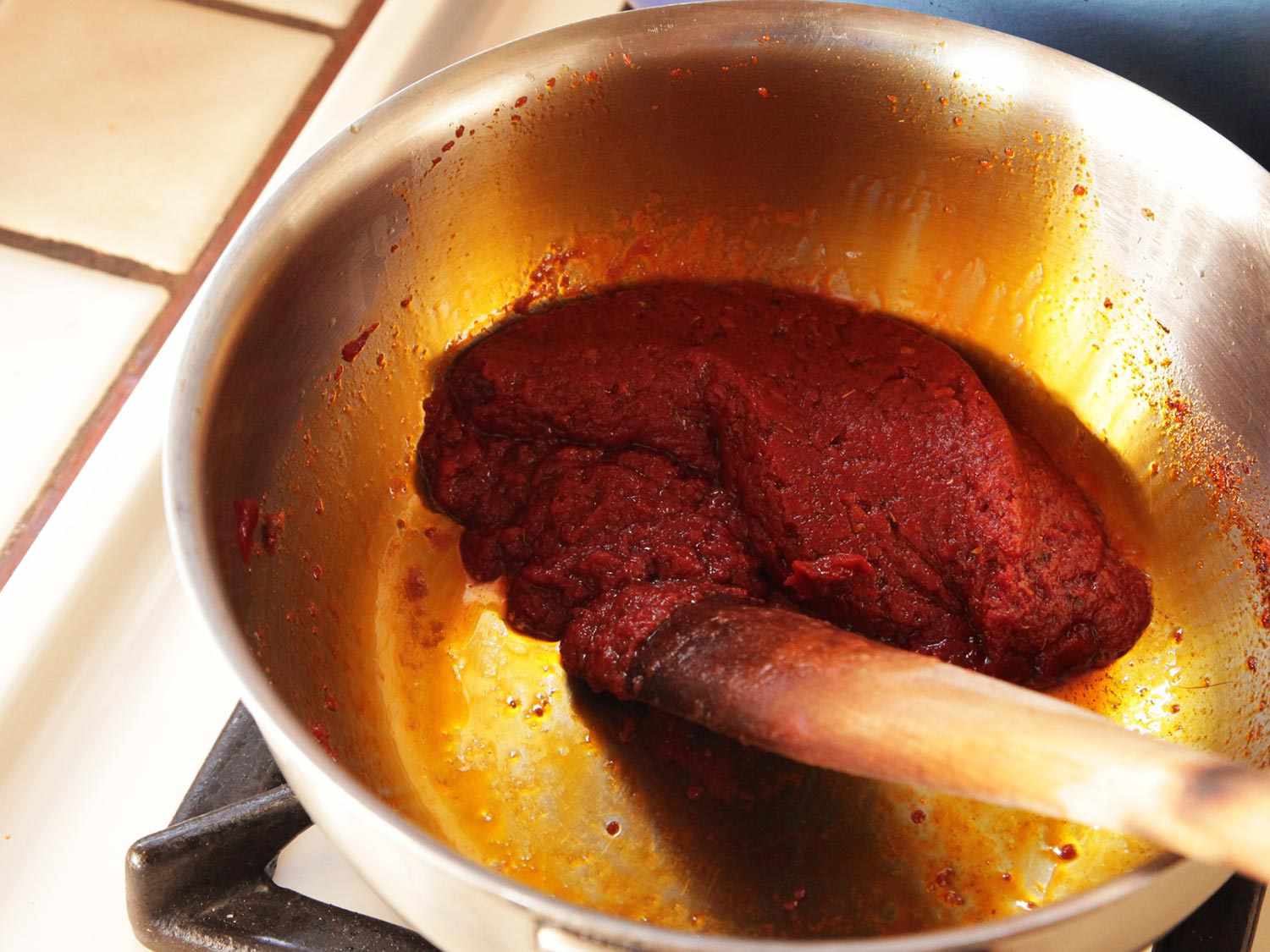 Frying tomato paste in olive oil