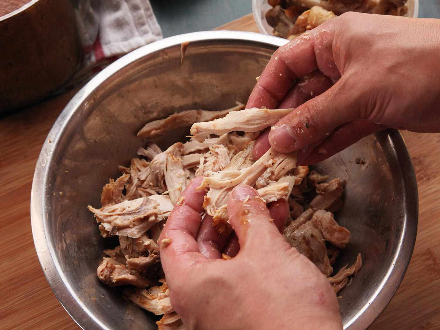 Author shredding chicken with hands. 