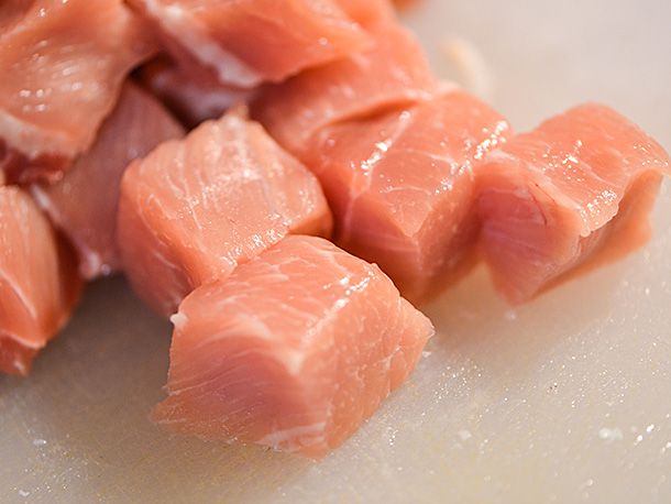 Cubes of raw pork.