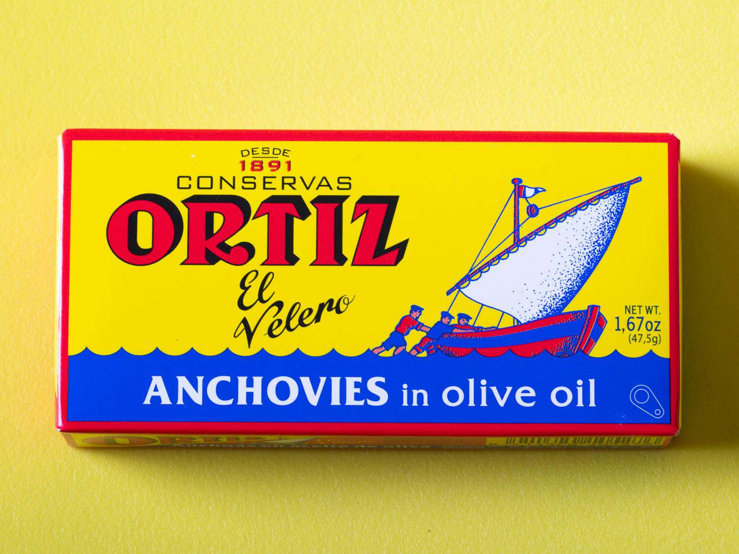 Packaging of ortiz anchovies on a yellow background.