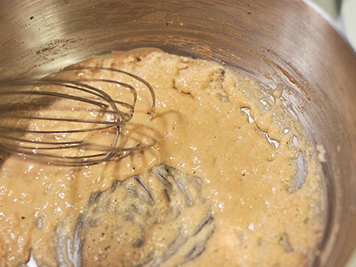Flour is whisked into the bacon grease to form a blonde roux.