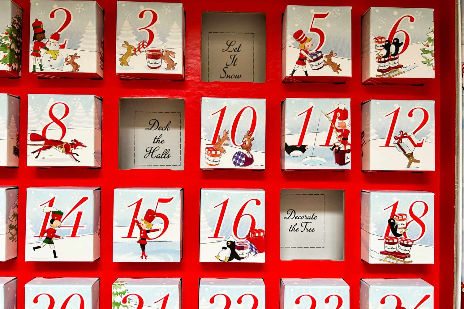 The Bonne Maman Advent calendar with some days already opened, revealing festive sayings inside.