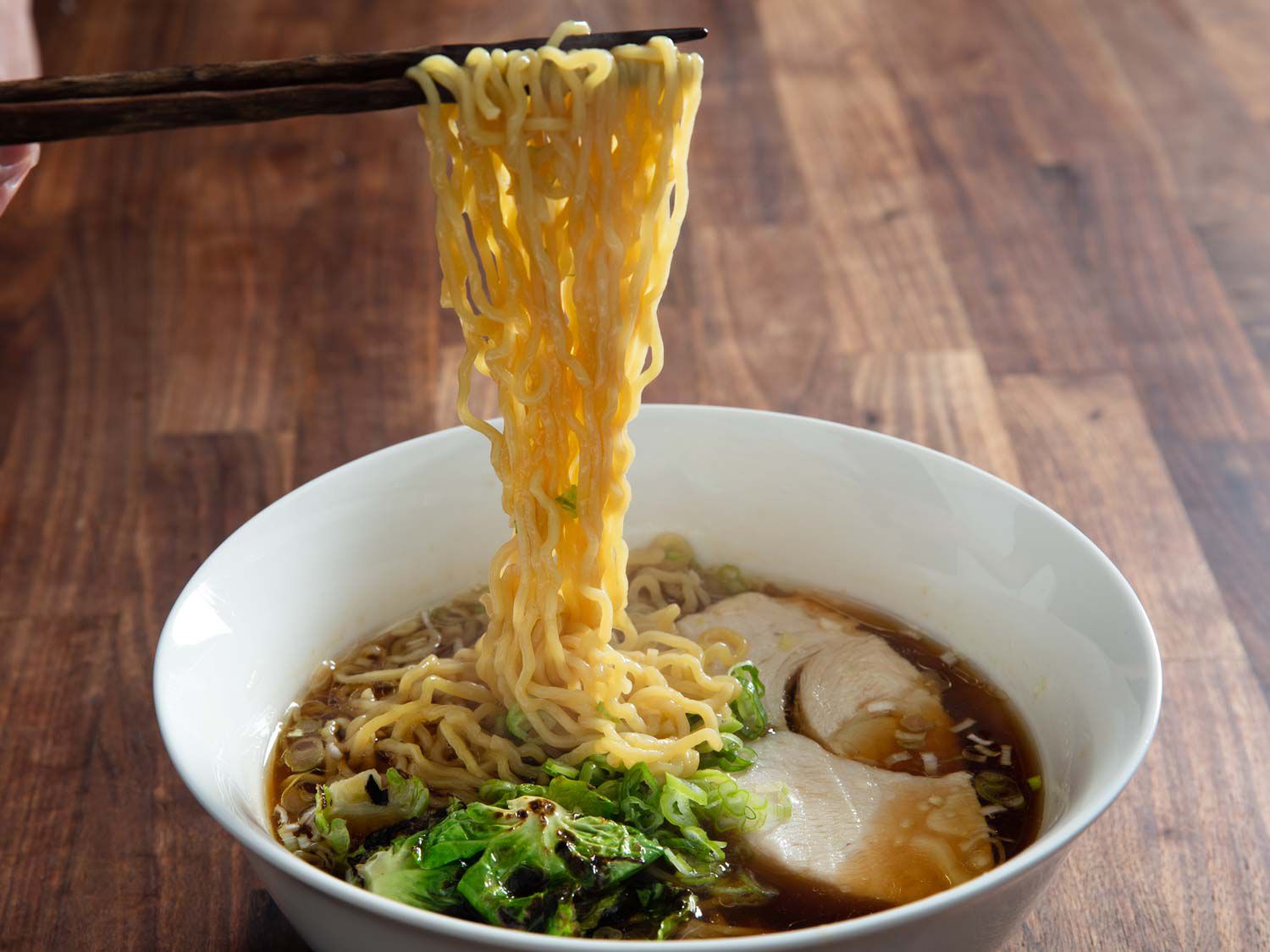 Noodles being lifted out of bowl of turkey chintan ramen