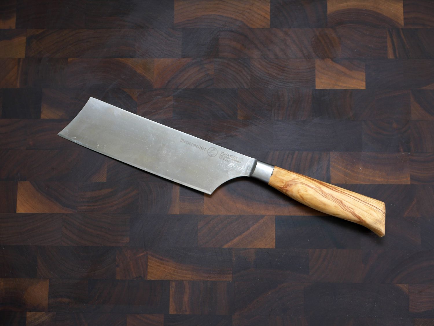 messermeister nakiri knife on a wooden cutting board