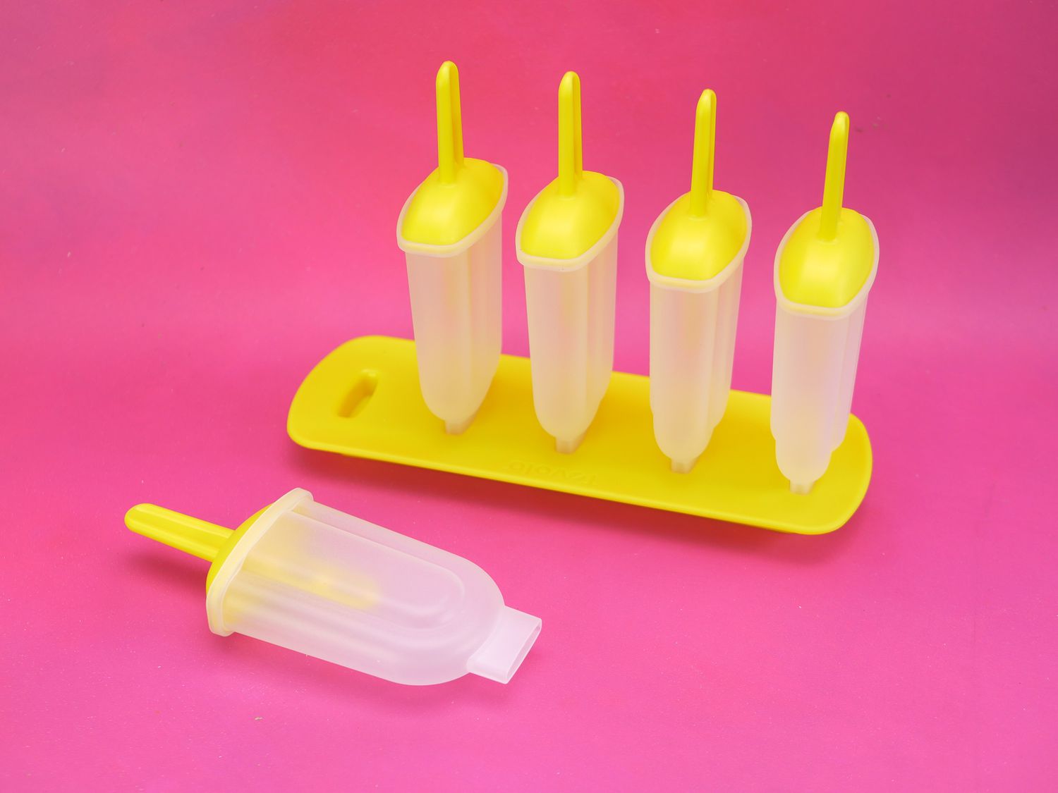 tovolo classic popsicle molds on a pink background