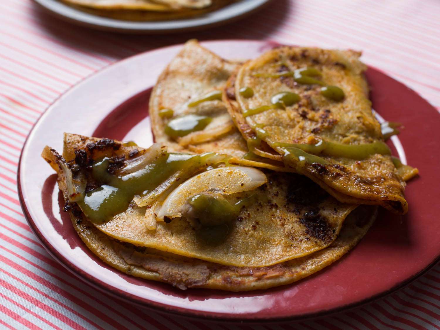 3 tacos de canasta plated with salsa verde