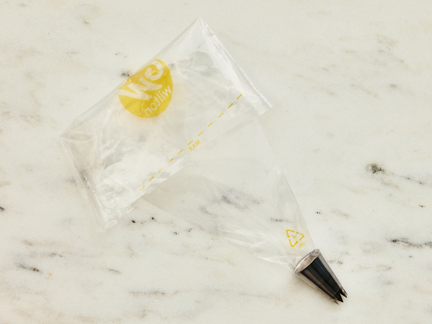 Piping bag on white marble surface 