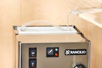 Closeup of a person pouring in water into the Rancilio Silvia Espresso Machine water tank 