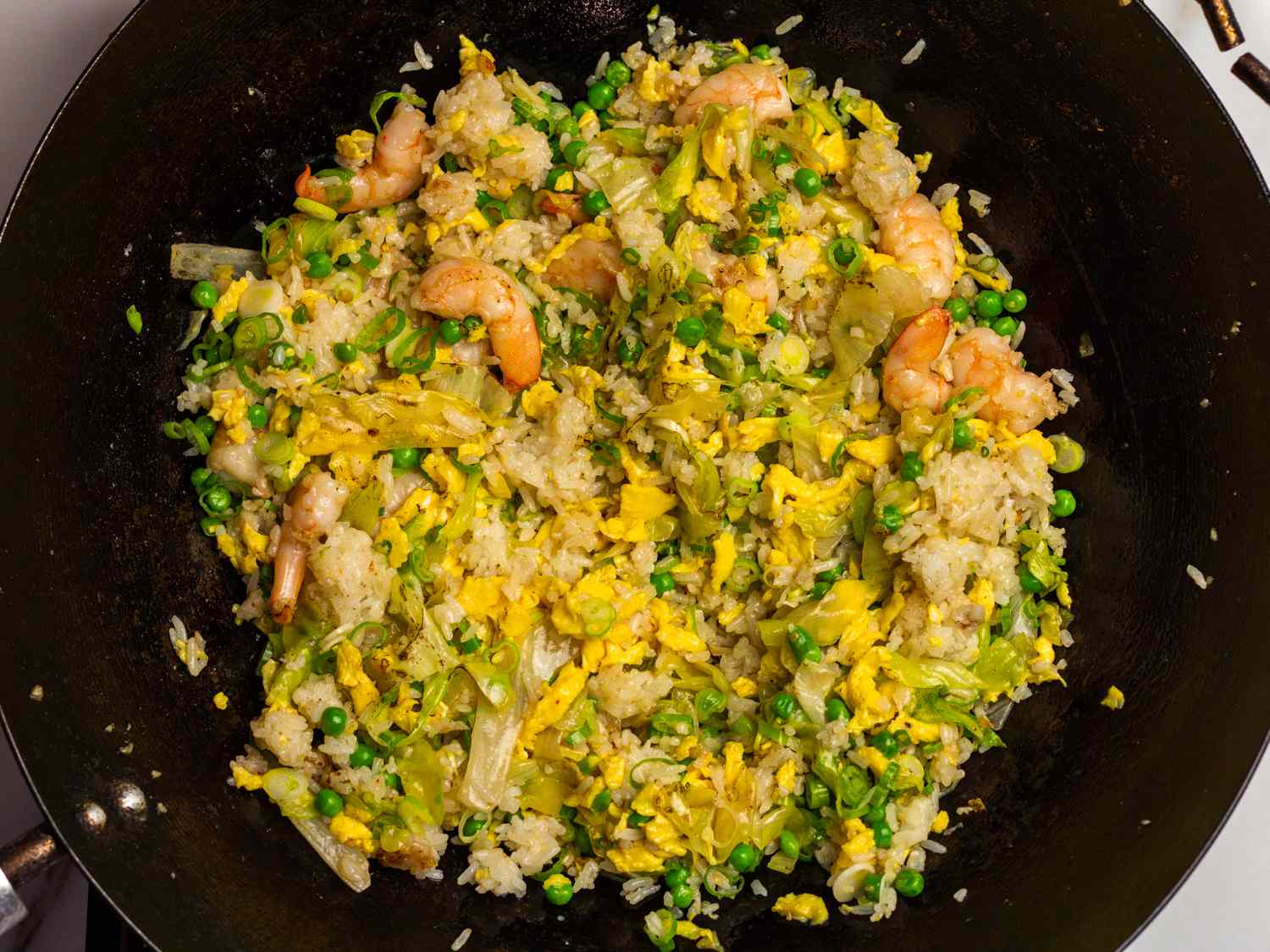 cabbage, rice, and peas added back to wok with shrimp 
