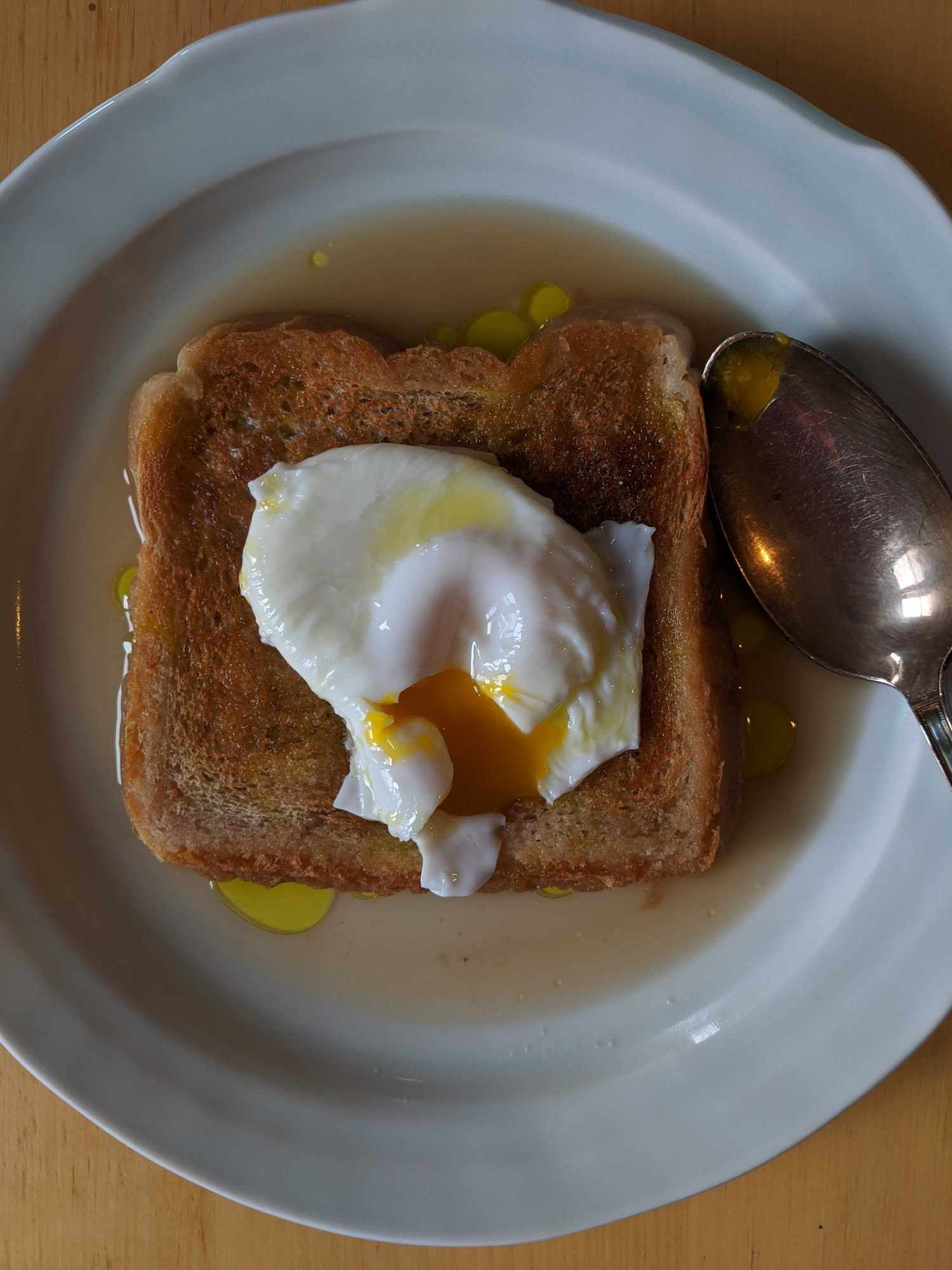 Poached egg on toast submerged in chicken broth