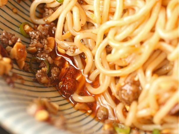 Chile oil pooled in bottom of a bowl of Dan Dan Noodles