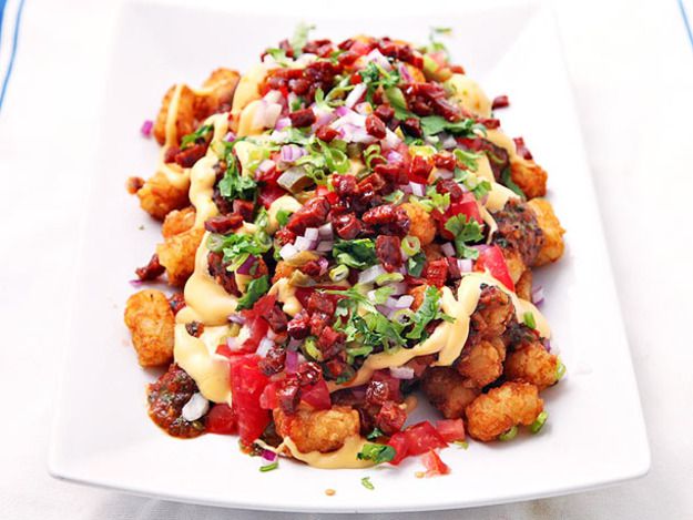 Totchos (Tater Tot Nachos) with Cheese Sauce, Charred Tomato Salsa, Chorizo, and Pickled Jalapeños.