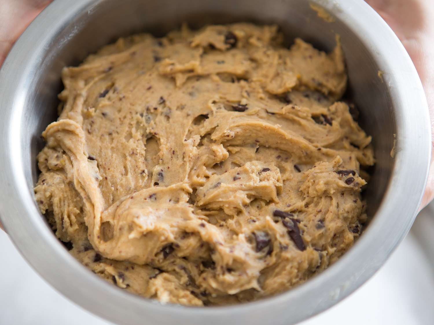 Chocolate chip cookie dough in a metal bowl 