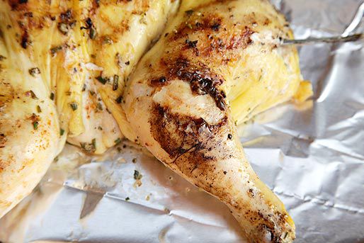 Close-up of the hot-start chicken's right leg. The skin has charred and torn around the joint.