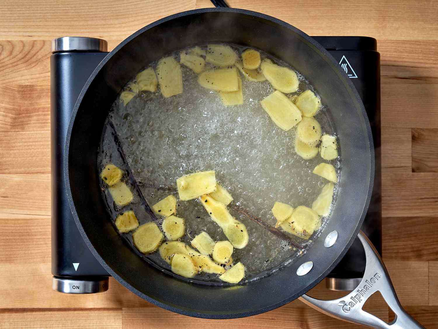 Ginger. sugar, and vanilla beans in boiling water.