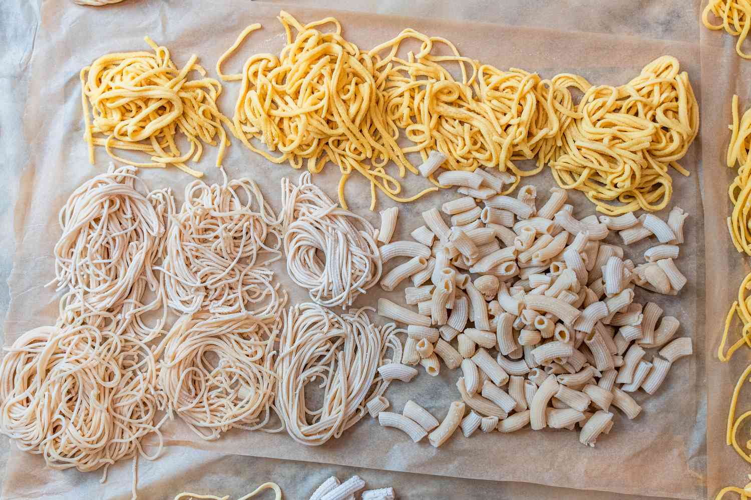 Piles of fresh pasta on a piece of parchment paper