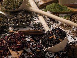 Variety of looseleaf teas and herbs scattered on a surface
