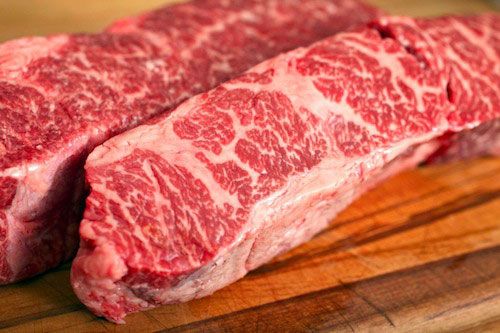 Closeup of two slabs of well-marbled boneless short rib.