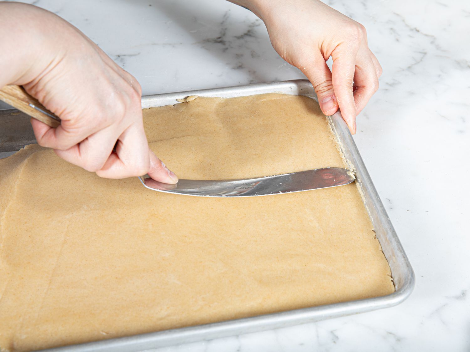 Overhead view of smoothing dough 