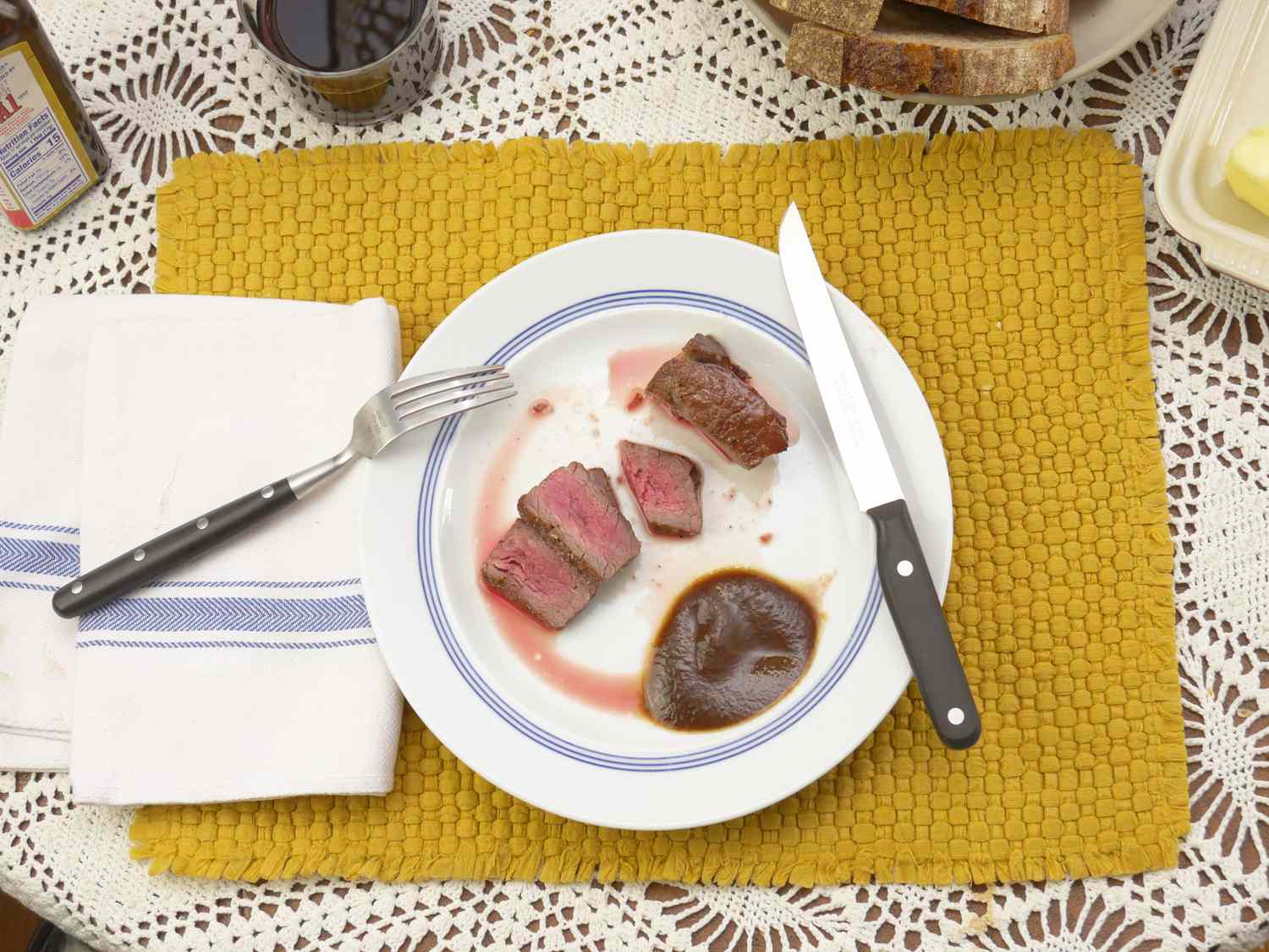 williams sonoma steak knife resting on a plate with sliced steak