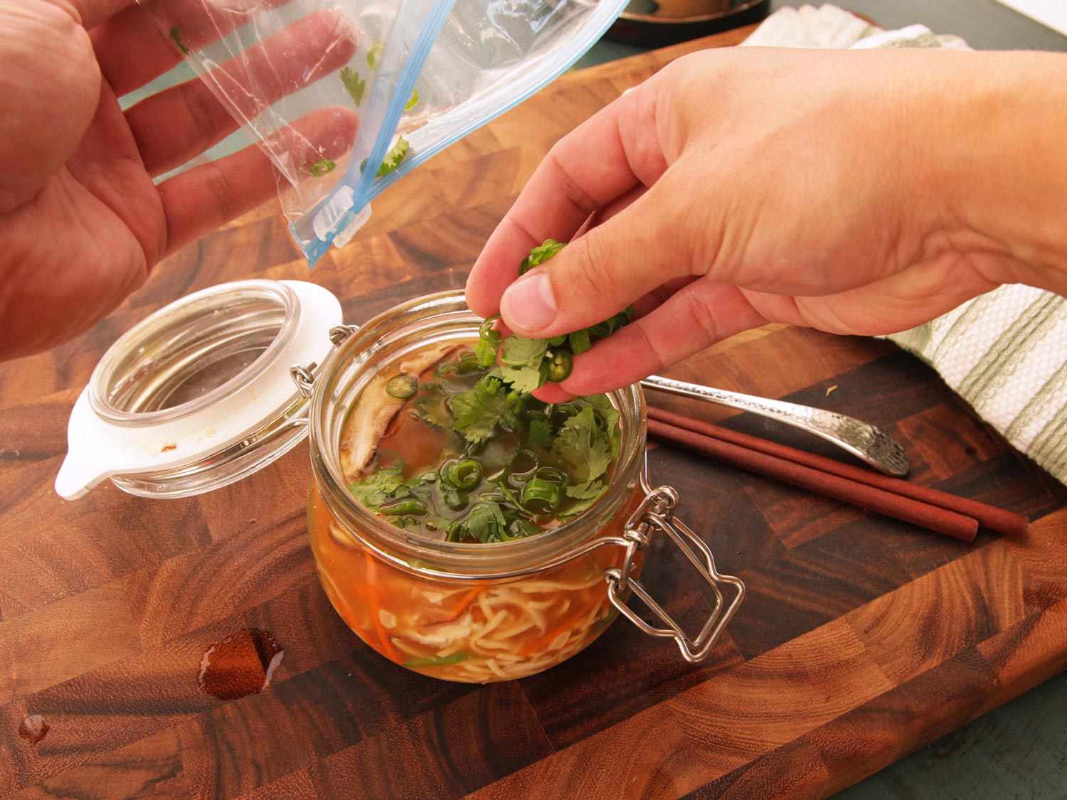 Herbs are added to homemade instant noodles from a flavor pack.
