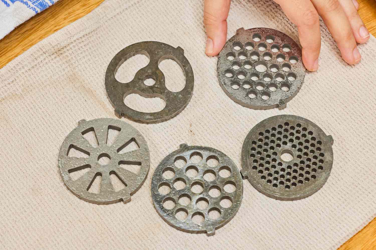 Different sizes of grinding plates of STX International Turboforce Classic 3000 Series Electric Meat Grinder & Sausage Stuffer