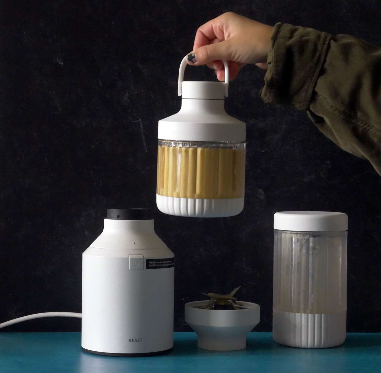 lifting up the to-go container filled with a butternut squash smoothie