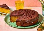 Brazilian carrot cake topped with chocolate glaze, a slice is served nearby
