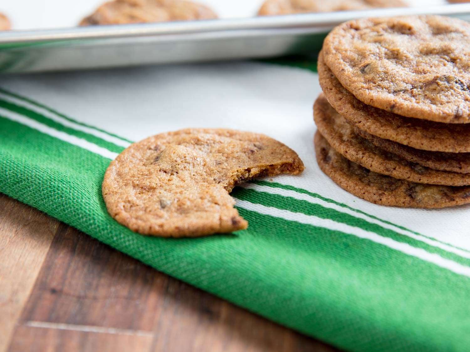 Sampling a bite out of a thin and crisp chocolate chip cookie.