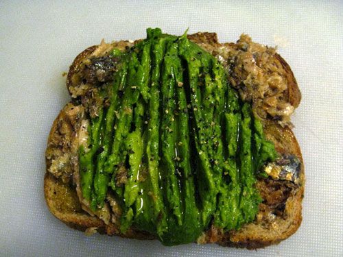 An open-face sardine avocado sandwich.
